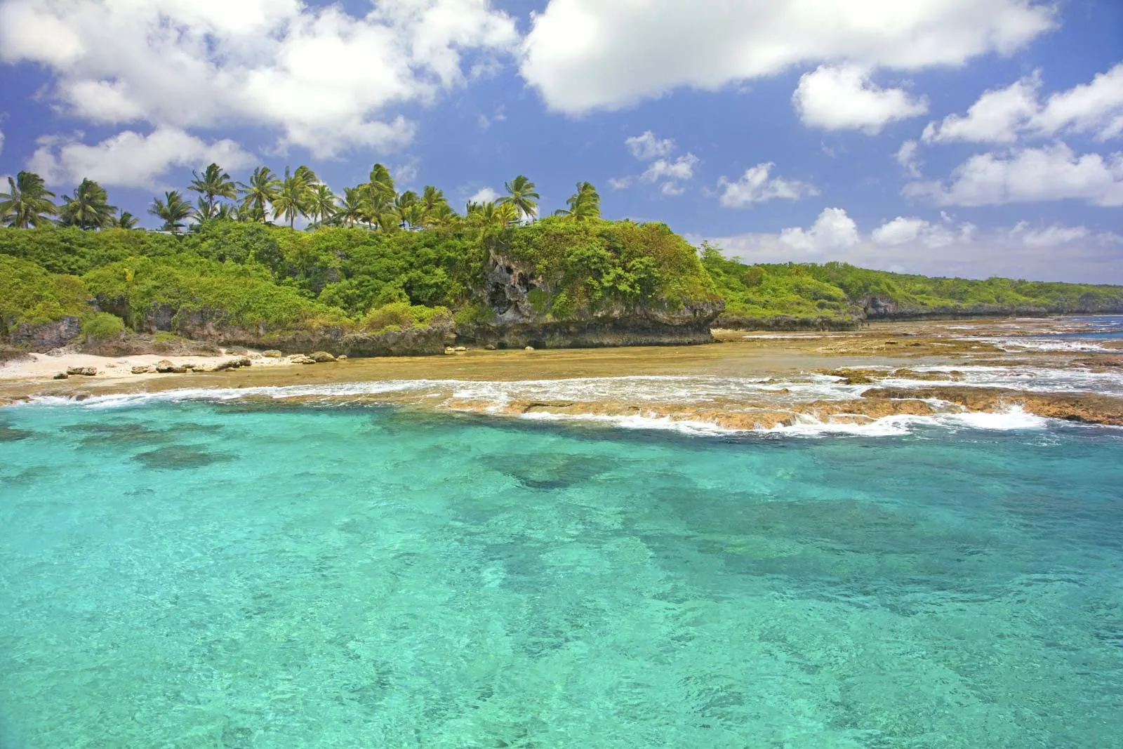 A beach with clear blue water in Niue