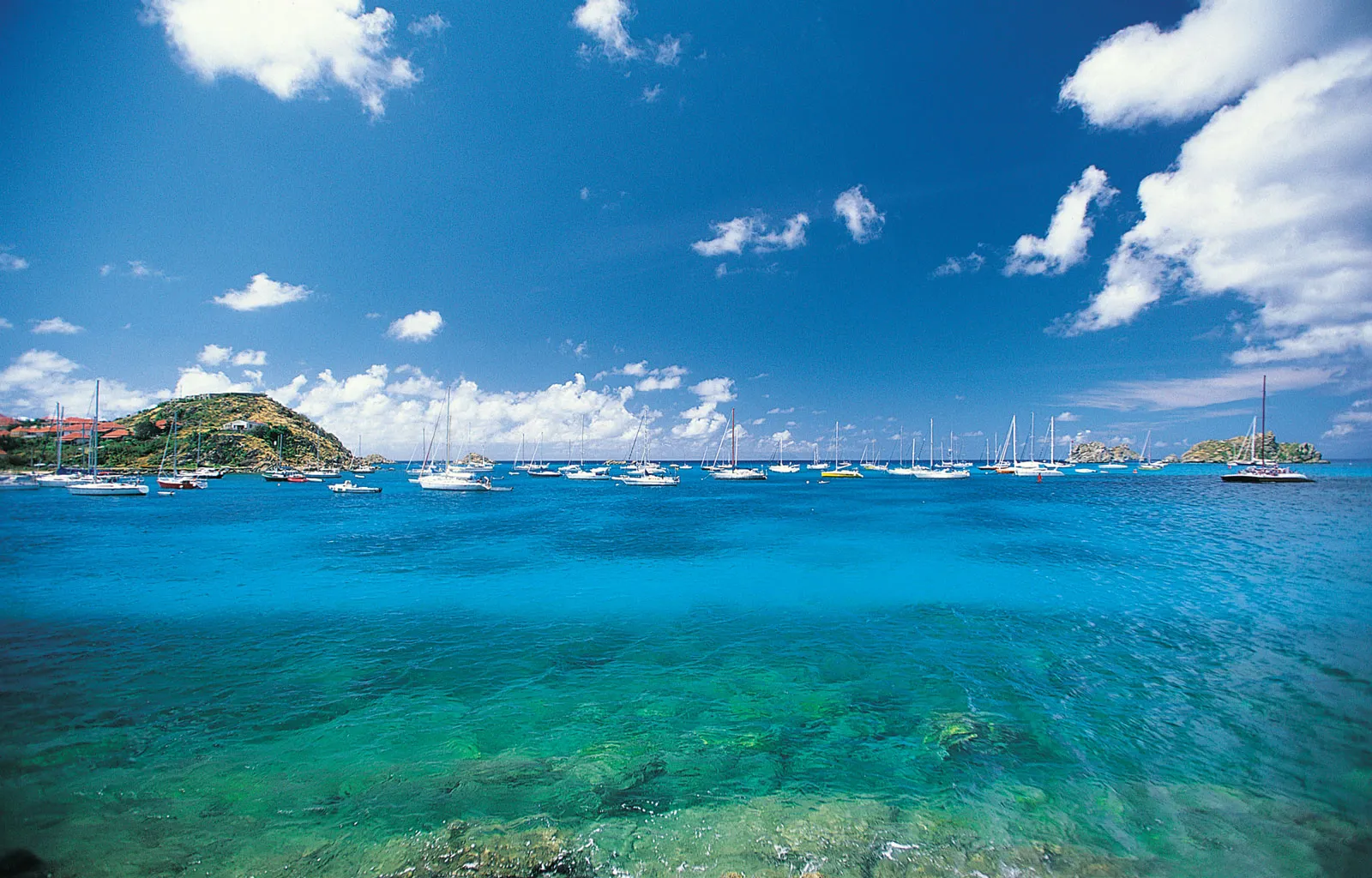 Beautiful blue ocean, blue sky, with boats in the horizon