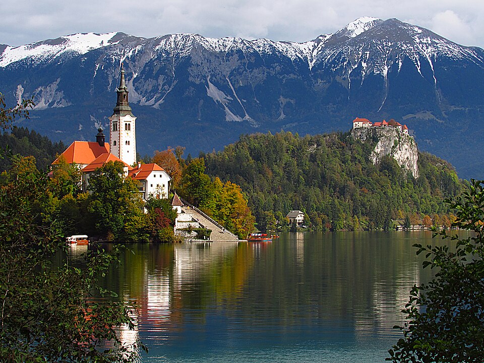 A castle, forest, and mountains surround Lake Bled